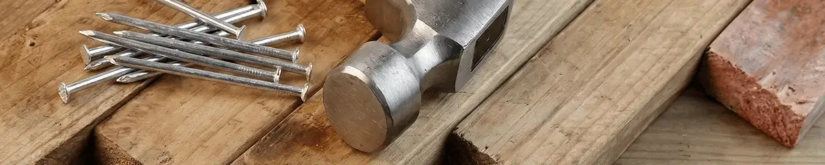 Hammer and nails on hardwood flooring boards in Nashville, TN
